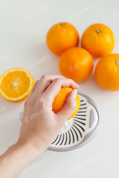 Preview: Making fresh healthy orange juice with manual juicer hand citrus squeezer
