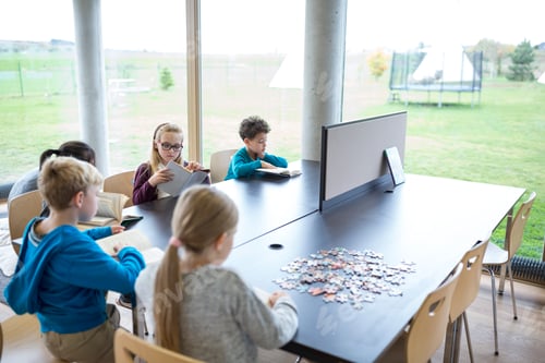 Preview: Pupils reading books on table in school break room