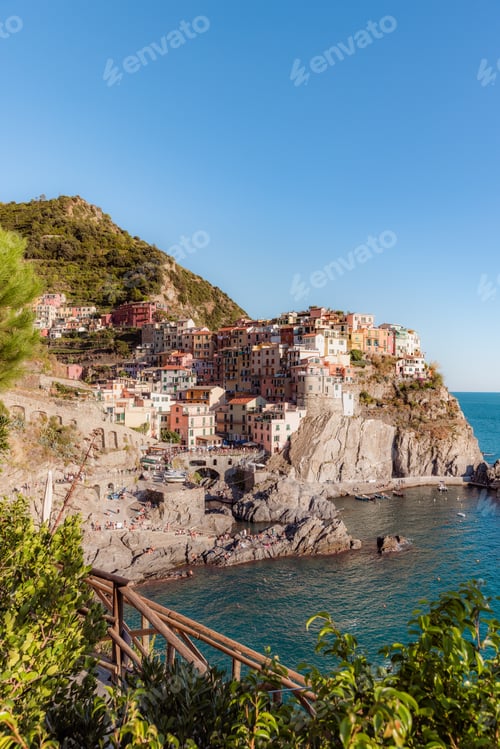 Preview: village of Manarola with colorful houses perched on steep hills that slope down to the sea