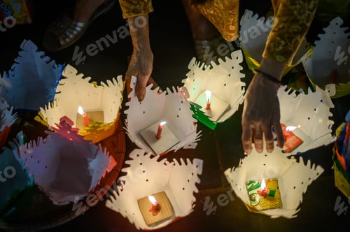 Preview: Growing anonymous person light candles in lantern before launching on festival day in Vietnam