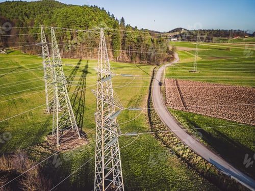 Preview: Drone view of three electrical power towers in the countryside