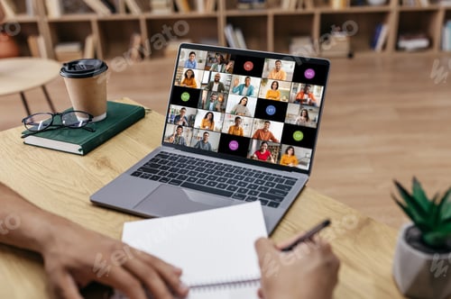Preview: Person Taking Notes During a Video Conference Meeting in Office