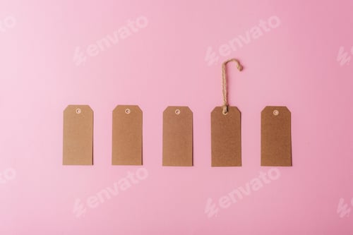 Preview: Brown kraft paper tags on pink background. Minimal flat lay. Top view, mockup