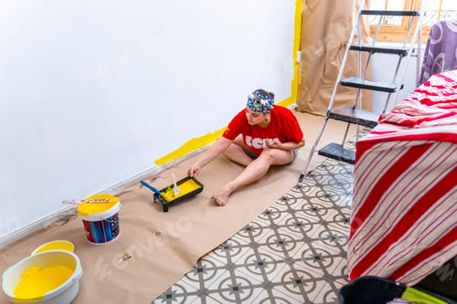 Preview: Painting Happiness: Middle-Aged Woman Smiling while Renovating Her Home