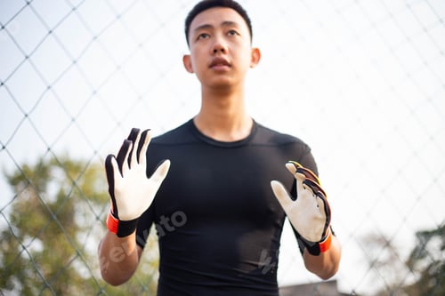 Preview: male amateur player practicing as a goalkeeper position rehearsing to catch the ball.
