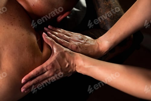 Preview: Close-up of female masseur hands doing medical relax muscle shoulder massage for male