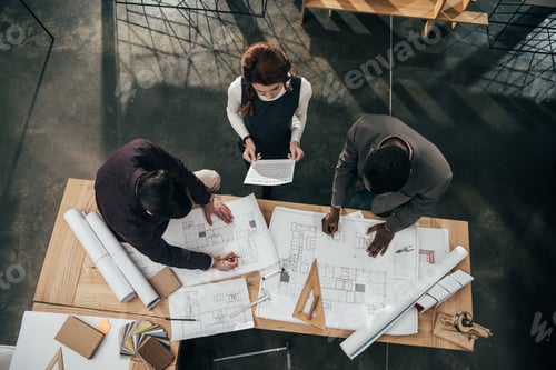 Preview: high angle view of team of architects working at office