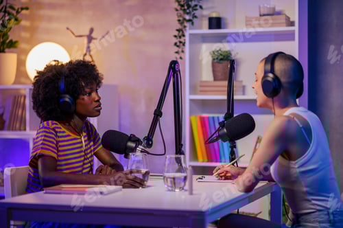 Preview: Two co-hosts are discussing topics and making video content in a podcast studio