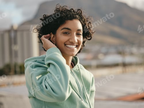 Preview: Face, smile and happy young woman feeling free and happy while smiling outside against an urban cit