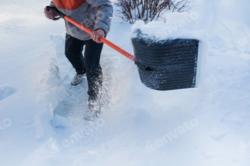 Preview: Man clearing snow by shovel after snowfall. Outdoors.