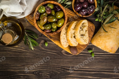 Preview: Olives, olive oil and ciabatta on wooden table