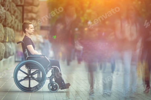 Preview: The invalid man sit in the wheel chair in the crowd flow on the street