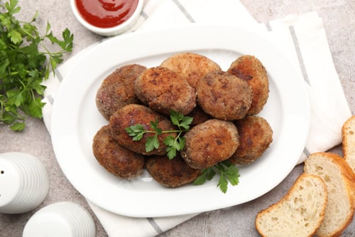 Preview: Tasty meat patties served on grey table, flat lay