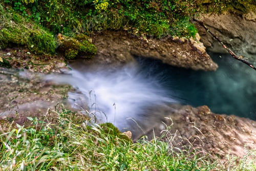 Preview: High angle shot of a small river stream and green trees in Bad Urach in Germany