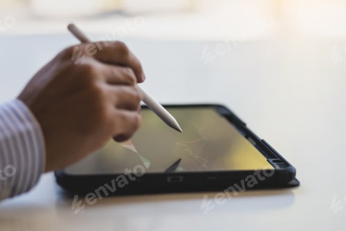 Preview: Investors analyzing stock market and forex trading chart data on tablet.