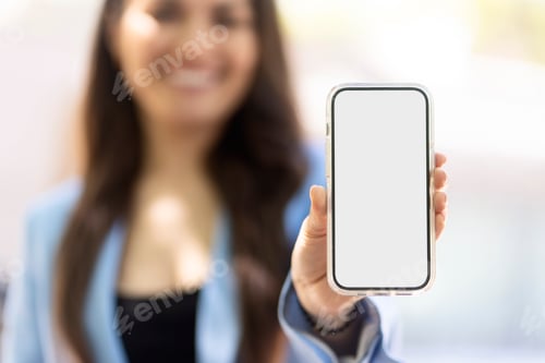 Preview: Businesswoman showing smartphone with blank screen for mobile app design