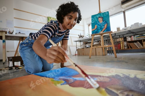 Preview: Studio, art and a woman painting on floor in design school with creativity and paint brush. Artist