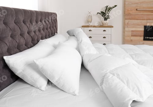 Preview: Large comfortable bed in light room. Stylish interior