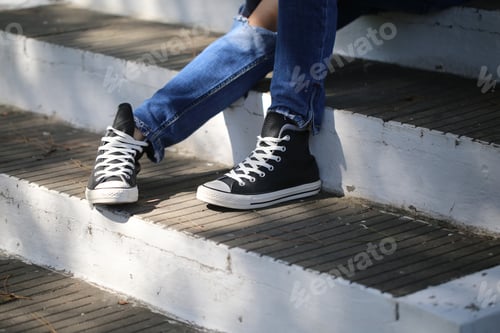 Preview: Girl'S Legs In Jeans And Sneakers