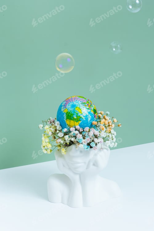 Preview: Creative plaster vase head-shape with flowers and world globe. Save the planet, Earth day concept