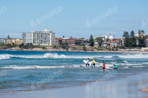 Preview: Four teenage girls are ready to surf at North Cronulla Beach. Sydney, Australia