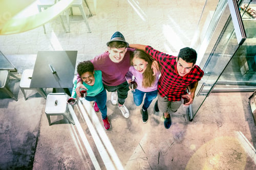 Preview: Top view of multiracial friends walking to cocktail bar restaurant
