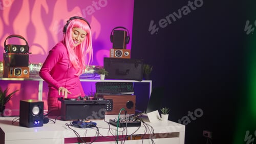 Preview: Asian musician with headphones playing electronic song