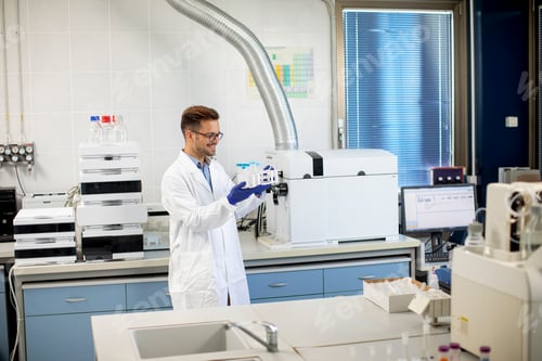 Preview: Handsome young researcher workin with chemical samples