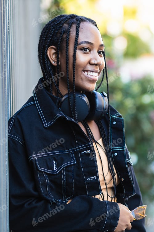 Preview: Black woman leaning on wall near park