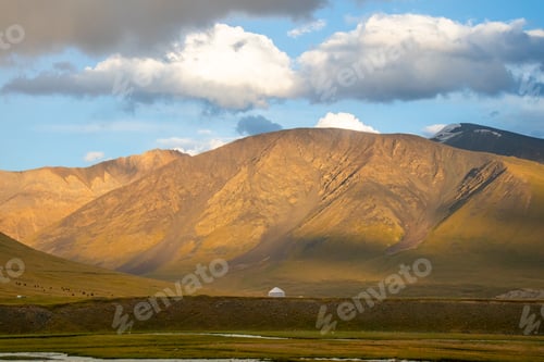 Preview: Yurt and mountains under a cloudy sky