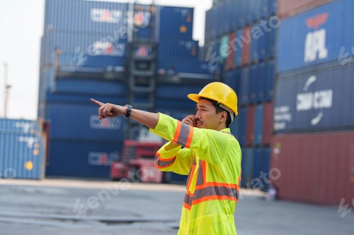 Preview: Worker communicates directions at busy shipping container yard during daytime