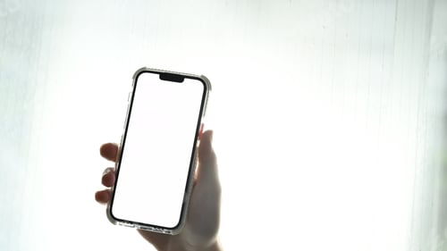 Preview: Man hands holding smart phone. Blank screen for your webpage or advertise text.