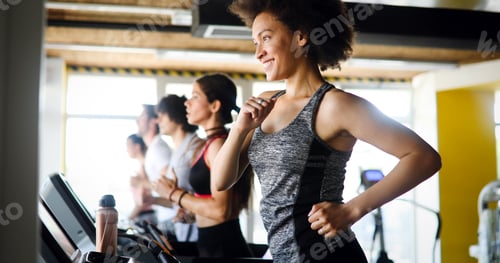 Preview: Group of young people exercising on a treadmill at gym