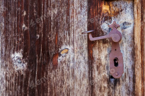 Preview: Rusty vintage door handle on an old wooden door