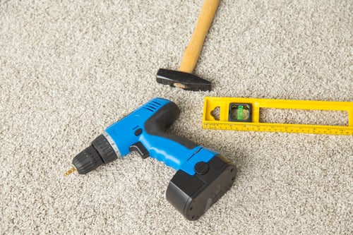 Preview: Hammer, drill and builders level on the floor
