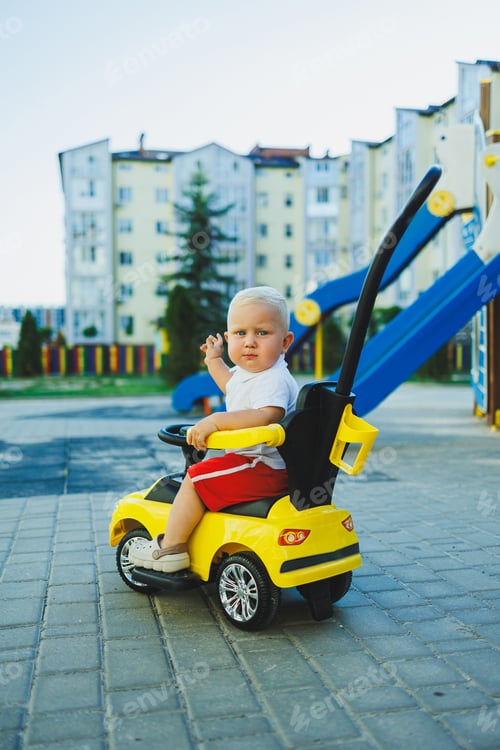 Preview: A little boy rides a tolocar. Tolokar for babies. Children's car for skating.