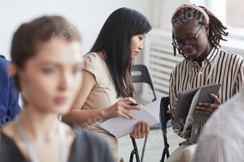 Preview: Two Businesswomen at Conference