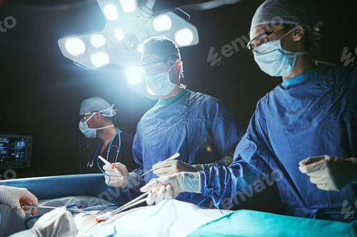 Preview: Surgeons Working Attentively in Operating Room Under Lights