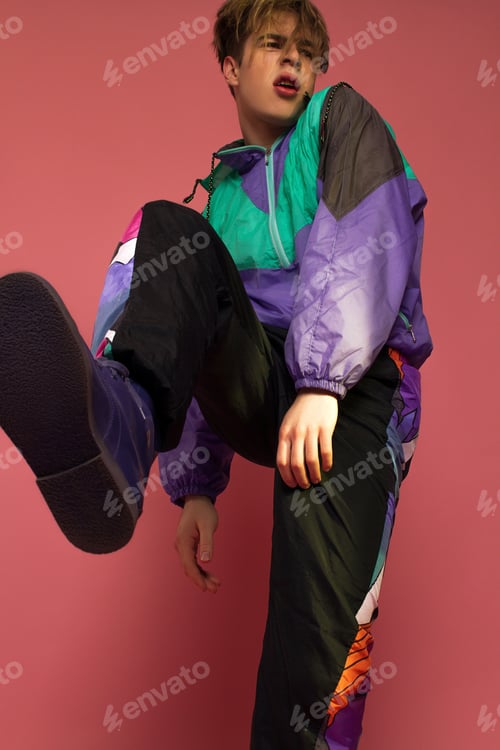 Preview: A Guy Hipster In A Sports Suit Posing On A Pink Background