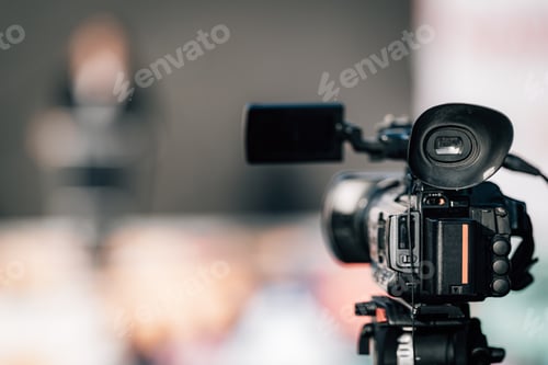 Preview: Close-up Image of a Camera at an Outdoor Press Conference