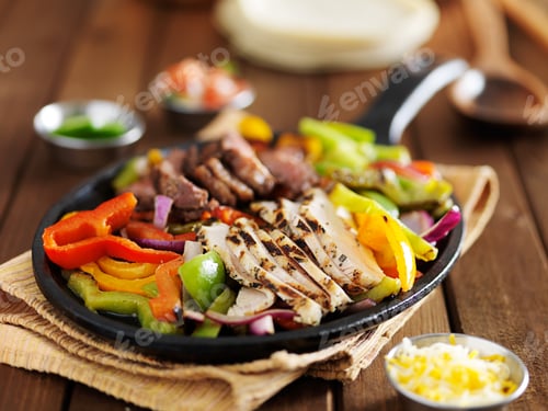 Preview: chicken and steak mexican fajitas in iron skillet