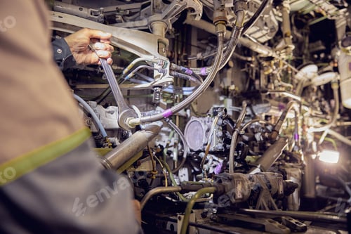 Preview: Aviation mechanic is working on undercarriage area