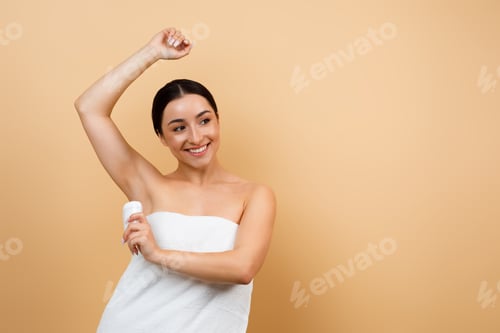 Preview: Beautiful Young Indian Female Wrapped In Towel Using Antiperspirant Stick Underarms