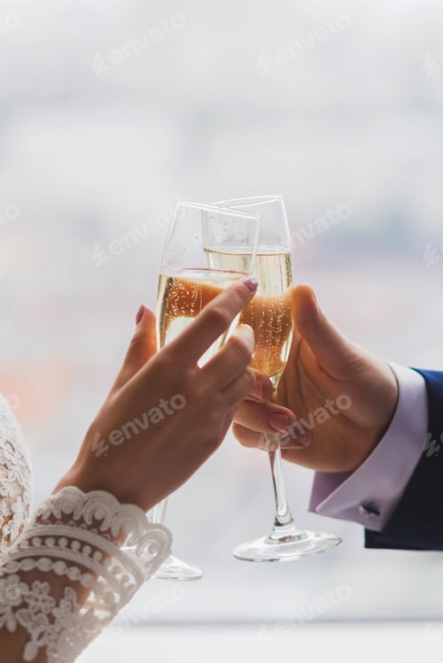 Preview: Toasting Champagne Glasses During Celebration of Marriage