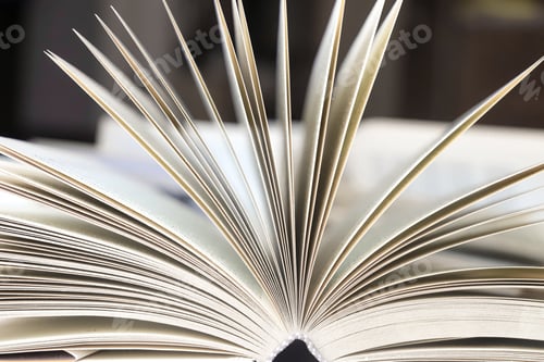 Preview: stack of books, close up. Open book on the table in library. Back to school concept. Open book on ta