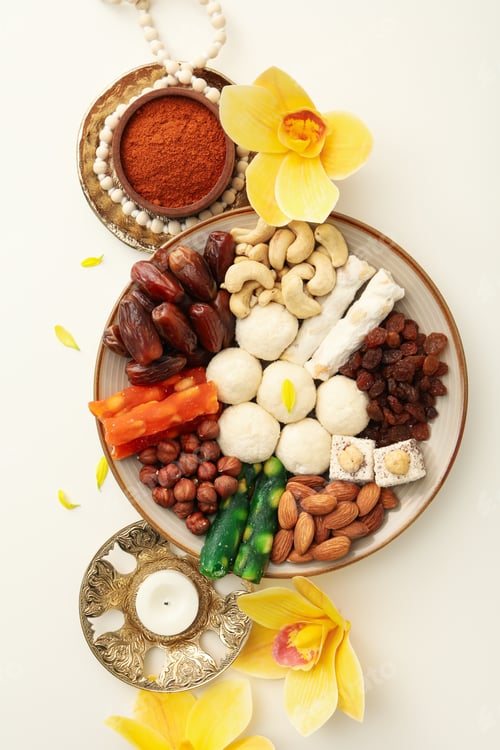 Preview: Plate with sweets, candle, flowers and spices on white background, top view