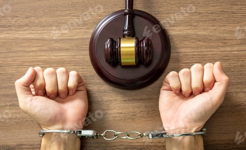 Preview: Handcuffed Convict. Court sentence Prison. Handcuff locked and judge gavel on table, top view..
