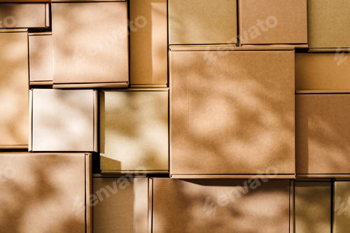 Preview: Stacked cardboard boxes arranged in a neat pattern under natural light