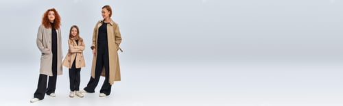 Preview: redhead family in coats posing while standing on grey background, happy female generations, banner