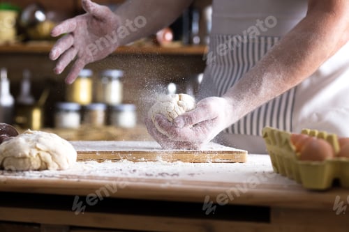 Preview: Close up of female baker hands kneading dough.